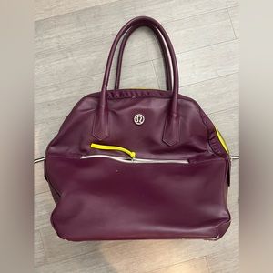 Lululemon weekender bag. Purple. W/inside pouch. Scuff on the bottom. Sold as is